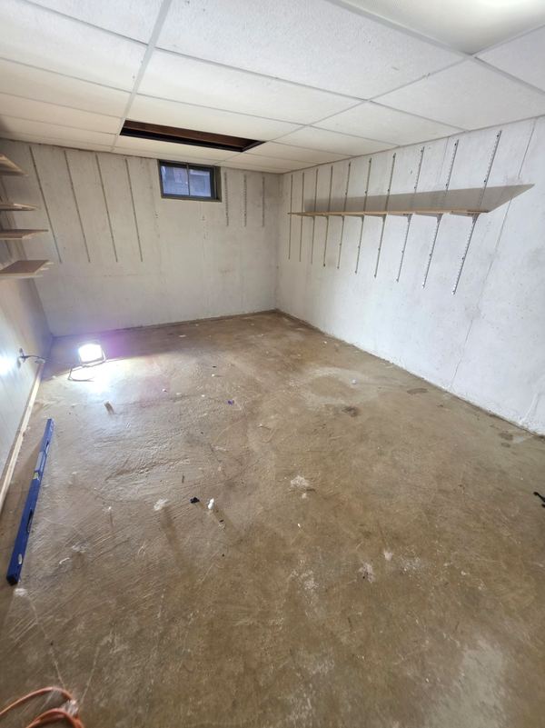 Unfinished basement with bare concrete floor