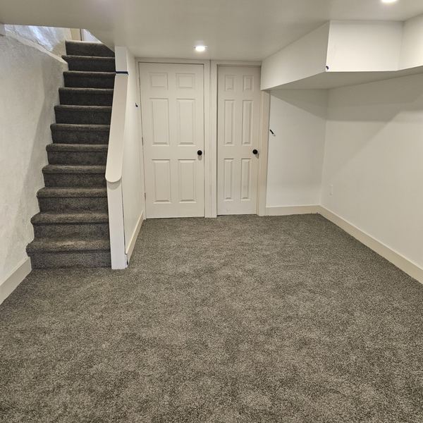 Finished basement with new carpet and stair runner