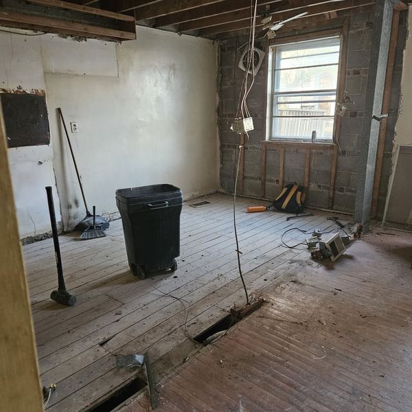 Kitchen gutted to the subfloor and framing before renovation