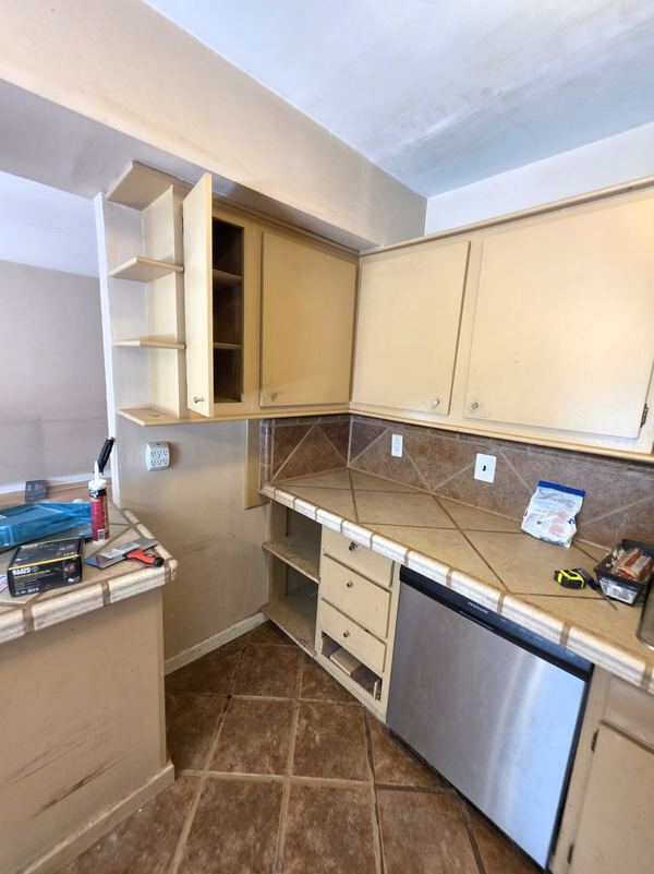Dated kitchen with tan cabinets before a refresh