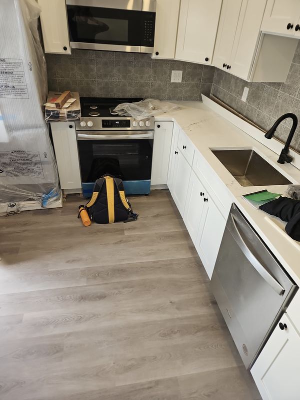 New kitchen with white cabinets and stainless appliances